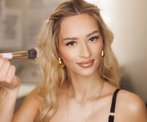 Beautiful fresh blonde happy woman with clear skin doing makeup